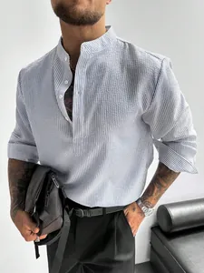 Close-up of men's striped long-sleeve shirt with stand collar and textured fabric.