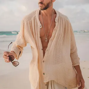 Close-up of beige men's cotton linen shirt showing fabric texture in a beach setting