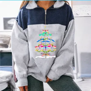 Detailed view of women's color-block half-zip sweatshirt with dragonfly Christmas tree print