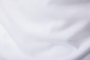 Close-up of the breathable white cotton fabric texture of a slim fit long sleeve T-shirt