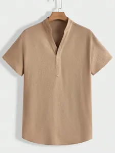 Detailed view of khaki men's short-sleeved shirt featuring textured crinkle fabric