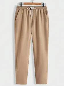 Men's casual solid color long pants featuring elastic drawstring waist and textured fabric