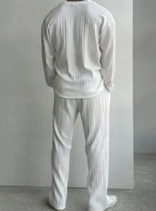 Back view of men's white pleated casual set with long-sleeved shirt and loose pants