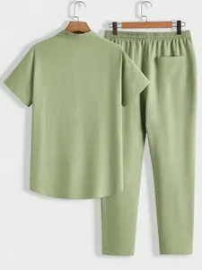 Back view of men's short sleeve and long pants sports set in textured green fabric