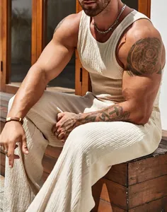 Detailed view of men's beige ribbed tank top and loose pants set showing fabric texture