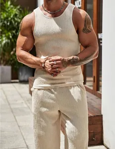 Detailed view of men's beige ribbed tank top and matching pants set for summer fitness.
