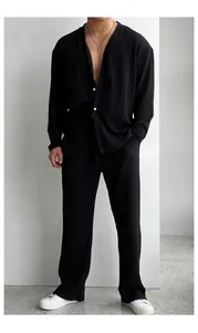 Detail view of men's black pleated casual two-piece long sleeve shirt and trousers set