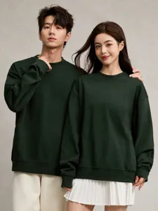 Detail of couple wearing dark green 380g heavyweight oversized crewneck sweatshirts