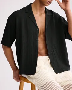 Detail of a men's relaxed black short-sleeve shirt with ripple textured fabric