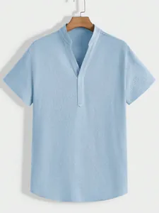 Detailed close-up view of a light blue men's short-sleeve henley shirt with textured fabric