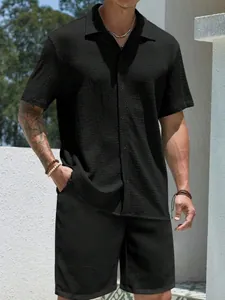 Close-up of a men's black textured waffle knit short sleeve shirt and shorts summer set