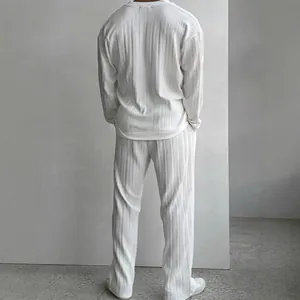 Elegant men's white pleated two-piece set featuring a long sleeve top and long pants