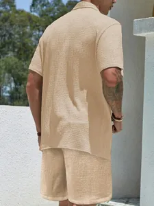 Back view detail of men's beige textured casual set with short sleeve shirt and relaxed shorts.