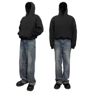 Front and side views of a black heavy cotton boxy hoodie with wide blue jeans.