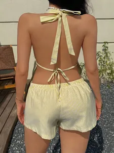 Back view showing halter neck tie and elastic waist on yellow striped shorts set.
