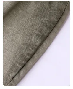 Macro detail of vintage washed cotton fabric with gradient color and neat stitching.