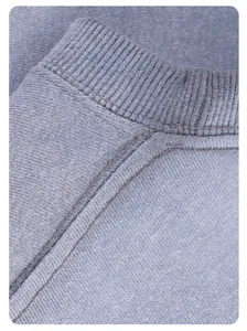 Close-up of the ribbed neckline and heavy knit texture of a washed blue sweatshirt.