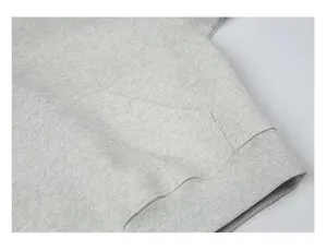 Close-up detail of kangaroo pocket and ribbed hem on a heavy grey marl cotton boxy hoodie