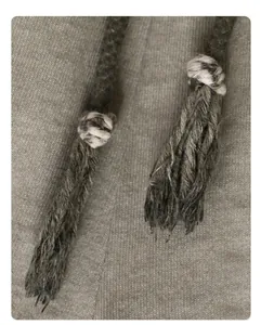 Close-up of retro washed cotton fabric with thick braided tassel drawstrings detail