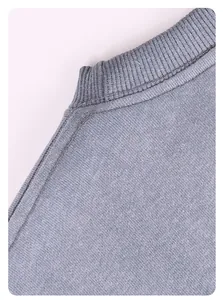 Close-up view showing the collar ribbing and stitching of a washed grey sweatshirt.