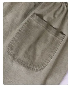 Close-up detail of retro acid-wash cotton fabric featuring a stitched pocket design