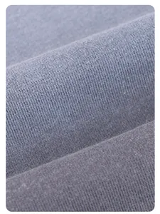 Detail view of heavy washed blue French Terry fabric texture for oversized sweatshirt.