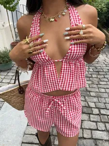 Detail view of a red and white gingham halter top and shorts set for women.