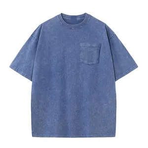 Oversized retro acid-washed blue T-shirt with chest pocket and drop shoulder design.