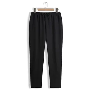 Pantalon décontracté noir pour homme sur cintre en bois avec finition texturée