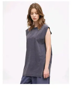 Female model wearing oversized vintage washed grey sleeveless vest in professional studio