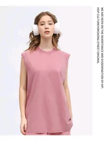 Visual view of a model wearing an oversized washed pink sleeveless vest with white headphones.
