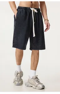 Close-up view of men's vintage washed distressed black shorts featuring white drawstring detail