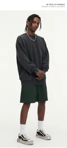 Full body view of oversized distressed washed black sweatshirt in streetwear style