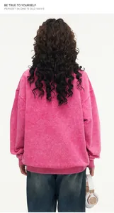 Detailed back view of a pink oversized acid-washed sweatshirt with soft cotton texture