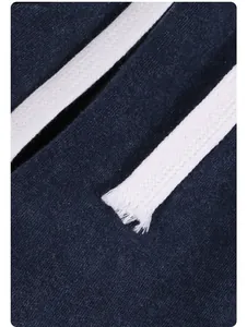 Close-up detail of white woven drawstring on navy blue vintage washed cotton fabric.