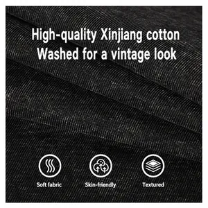 Close-up detail of high-quality washed cotton fabric with vintage distressed texture.