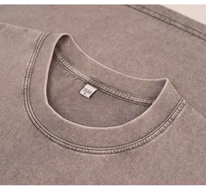 Detail showing the ribbed neckline and acid wash texture of the cotton t-shirt