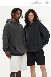 Detailed view of oversized vintage washed gray hoodies worn by models in a studio setting.