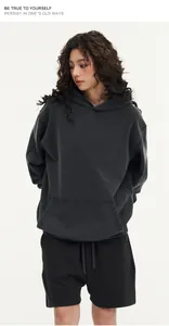 Detail of vintage washed distressed hoodie in oversize fit with front pocket