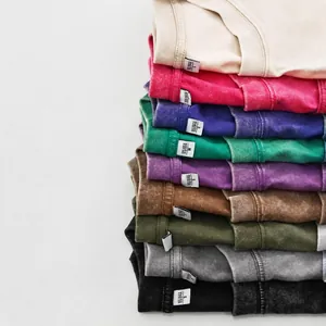 A stack of vintage washed cotton T-shirts in multiple colors featuring an oversize fit