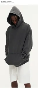 Close-up detail of vintage washed distressed oversized hoodie in charcoal grey