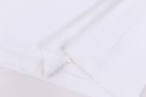 Close-up view of the distressed hem detail on a white 420g heavyweight cotton t-shirt.