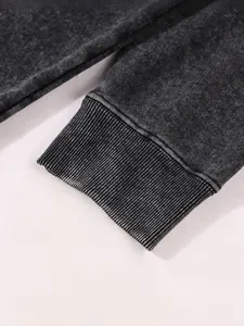 Detailed view showing the elastic ribbed cuff on a vintage washed grey oversized hoodie