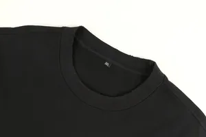 Close-up of distressed round neckline on a heavy black cotton t-shirt with 3XL tag
