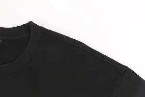 Detail shot showing the distressed ribbed neckline and shoulder of a black heavyweight T-shirt