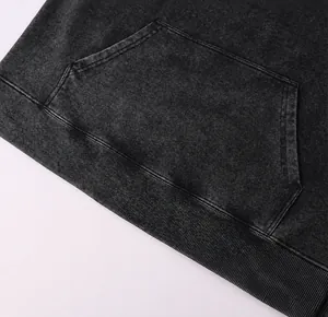 Macro view of vintage washed charcoal hoodie featuring a three-dimensional kangaroo pocket