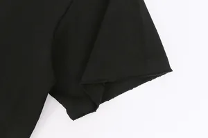 Detail view of heavyweight black cotton T-shirt sleeve with distressed raw edge hem.