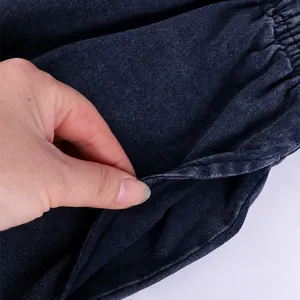 Close-up view of the functional side pocket on vintage washed cotton sports shorts.