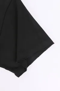 Macro view of distressed raw edge sleeve detail on black 420g heavyweight cotton T-shirt