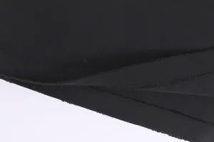 Macro view of distressed raw edge hem on a heavyweight black cotton t-shirt detail